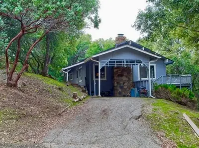 a small house with a driveway in front of it at Bald Bear Barracks in Mariposa