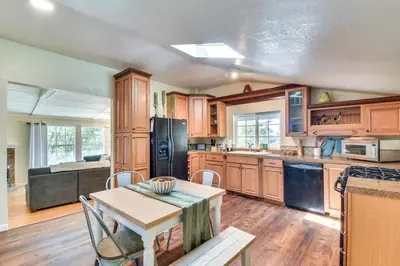 a kitchen with wooden cabinets and a table with chairs at Sonora Hilltop Home Scenic Views, Pet Friendly! in Sonora