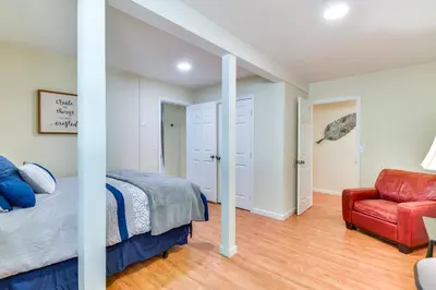 a bedroom with a bed and a red chair at Sonora Hilltop Home Scenic Views, Pet Friendly! in Sonora