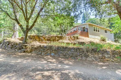 a house on a hill with a stone wall at Sonora Hilltop Home Scenic Views, Pet Friendly! in Sonora