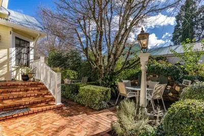 a patio with a table and chairs and a street light at Timeless Victorian Gem w Breathtaking Mountains in Sutter Creek