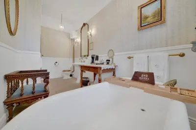 a room with a bathroom with a sink and a mirror at Timeless Victorian Gem w Breathtaking Mountains in Sutter Creek