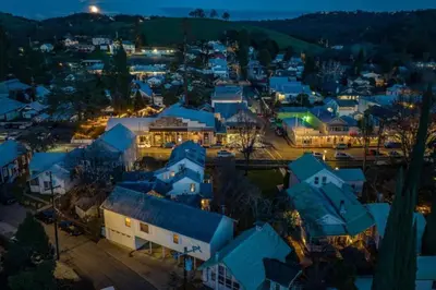 a small town at night with blue roofs at Romantic Victorian Getaway The Garden in Sutter Creek