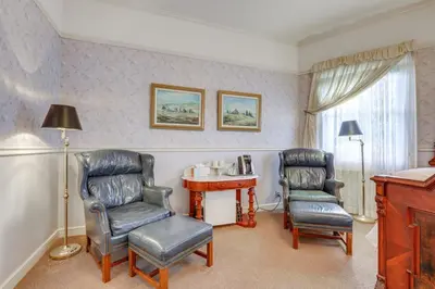 a room with two chairs and a table and a desk at Romantic Victorian Getaway The Blue Room in Sutter Creek