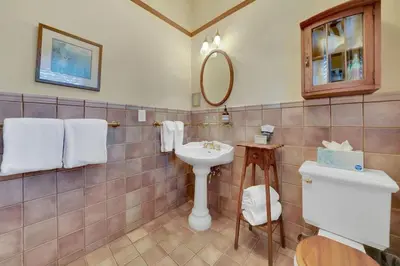 a bathroom with a sink and a toilet at Romantic Victorian Getaway The Fox in Sutter Creek