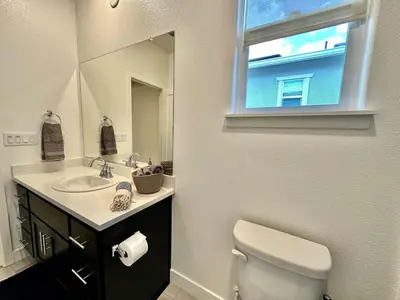 a bathroom with a toilet and a sink and a window at Charming and Modern 3-Bedroom Home in Rocklin in Rocklin