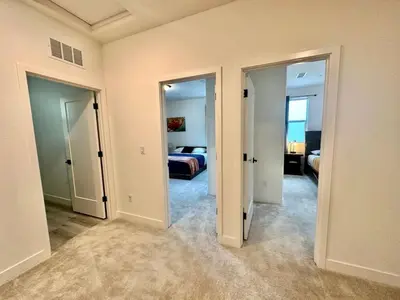 a room with two doors and a bedroom with a bed at Charming and Modern 3-Bedroom Home in Rocklin in Rocklin