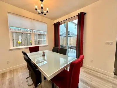 a dining room with a white table and red chairs at Charming and Modern 3-Bedroom Home in Rocklin in Rocklin