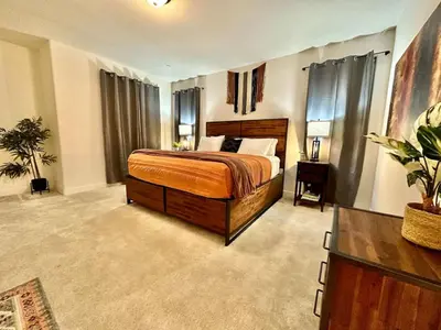 a bedroom with a bed and a dresser in it at Charming and Modern 3-Bedroom Home in Rocklin in Rocklin