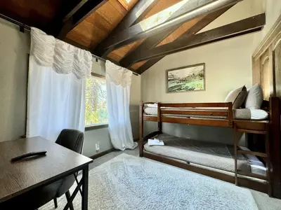 a bedroom with two bunk beds and a desk at Cozy Tahoe Retreat Huge Yard in South Lake Tahoe