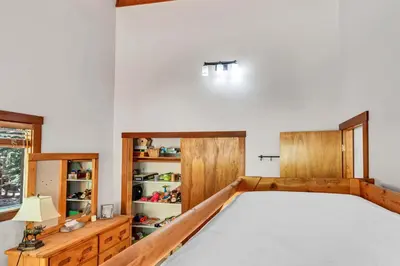 a bedroom with a large bed and wooden cabinets at Updated Tahoe Retreat Near Trails with Game Room in Kings Beach