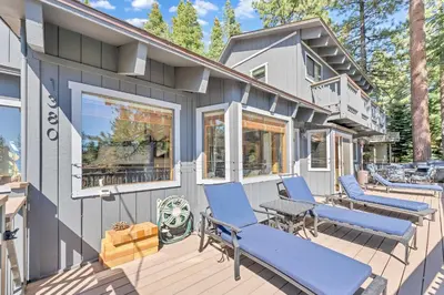 a house with blue chairs on a deck at Updated Tahoe Retreat Near Trails with Game Room in Kings Beach