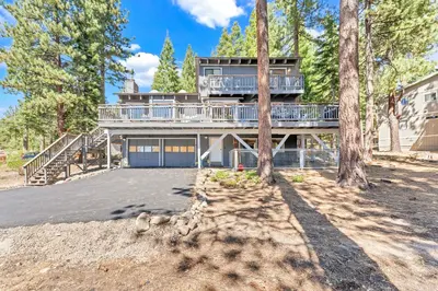 a large house with a deck on the side of it at Updated Tahoe Retreat Near Trails with Game Room in Kings Beach