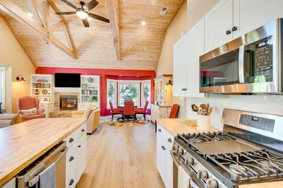 a kitchen with white cabinets and a stove top oven at Auburn Farmhouse with Fireplace, Close to Wineries in Auburn