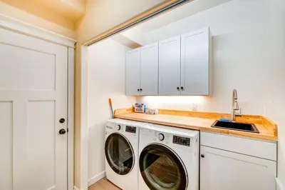 a laundry room with a washer and dryer at Auburn Farmhouse with Fireplace, Close to Wineries in Auburn