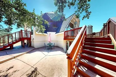 a house with a staircase and a deck at Lakeview Dome in La Grange
