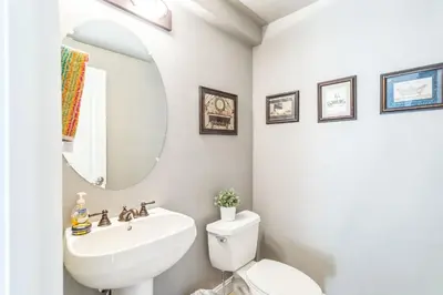 a bathroom with a sink and a toilet and a mirror at Beautiful Sunsets at 3BR Villa in Reno in Reno