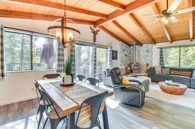 a living room with a table and chairs at 1 Mi to Pine Mountain Lake Marina Yosemite Cabin! in Groveland