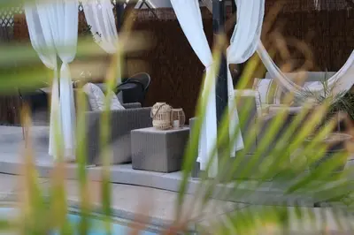 a table with some white curtains and some plants at Chic Boho 3BR Home Near Woodward Park in Fresno
