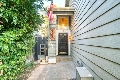 a house with a door and a bench in front of it at Chic Boho 3BR Home Near Woodward Park in Fresno