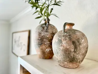 two vases sitting on a table with a plant in them at Chic Boho 3BR Home Near Woodward Park in Fresno