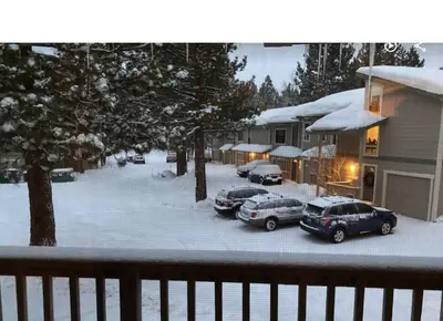 a group of cars parked in a snow covered yard at Mammoth TwnHm hot tub walk to town in Mammoth Lakes