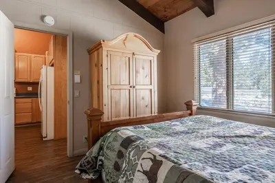 a bedroom with a bed and a large window at Mammoth TwnHm hot tub walk to town in Mammoth Lakes