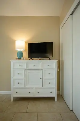 a white dresser with a television on top of it at Beautiful Condo by Park Entrance in Three Rivers