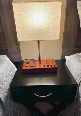 a table with a lamp on it next to two beds at Beautiful Condo by Park Entrance in Three Rivers