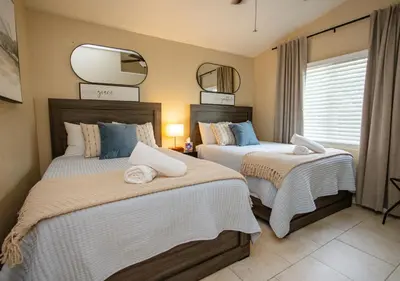 a bedroom with two beds and a tv on the wall at Beautiful Condo by Park Entrance in Three Rivers