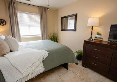 a bedroom with a bed and a dresser and a television at Cozy Condo minutes from the Sequoia National Park in Three Rivers
