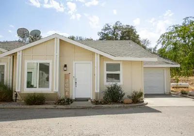a small house with a garage at Cozy Condo minutes from the Sequoia National Park in Three Rivers