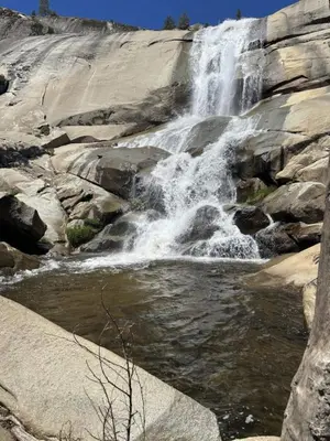 a waterfall on the side of a rocky mountain at Peppermint Falls Ranch in Ponderosa