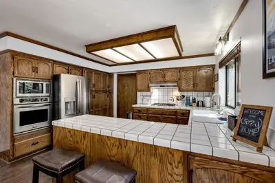 a kitchen with wooden cabinets and a white counter top at Large Seasonal Rental South Lake Tahoe in South Lake Tahoe
