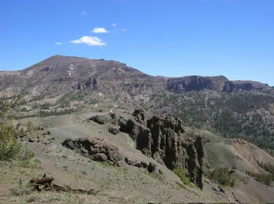 a mountain with rocks and trees in the foreground at Gold Dust West in Carson City