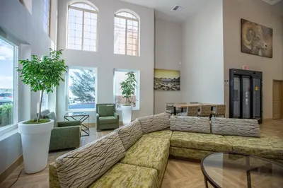 a living room with a large couch and some windows at Gold Dust West in Carson City