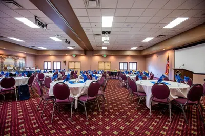 a banquet hall with tables and chairs in a room at Gold Dust West in Carson City
