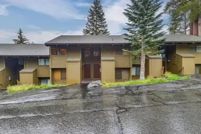 a building with a tree in front of it at Walk to Ski Lift Mtn-View Condo in Mammoth Lakes in Mammoth Lakes