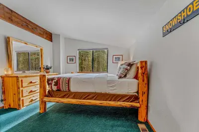 a bedroom with a wooden bed in a room at Near Northstar Wooded Retreat with Deck & Loft in Tahoe Vista
