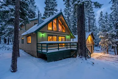 a house in the woods in the snow at Near Northstar Wooded Retreat with Deck & Loft in Tahoe Vista