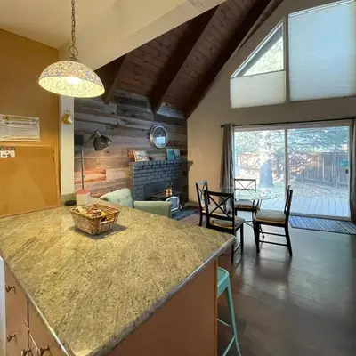 a kitchen and living room with a table and chairs at Spacious family home on the Meadow Monthly Only in South Lake Tahoe