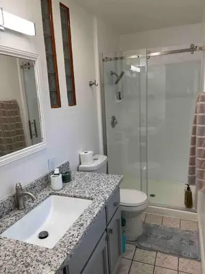 a bathroom with a sink and a shower and a toilet at Charming 3 Bedroom Farmhouse Retreat with Open Deck in Acampo