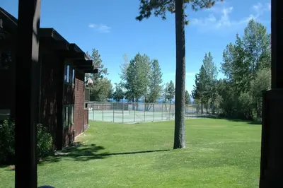 a tennis court with a tree in a field at TML 04 - Beautiful 1 BR Condo in Tahoe City in Tahoe City