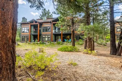 a house in the woods with trees at Solstice 17 in Mammoth Lakes