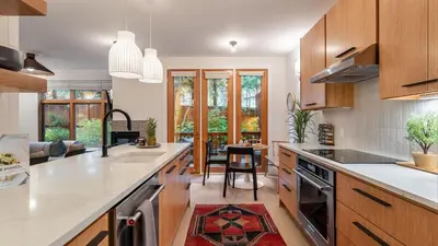 a kitchen with wooden cabinets and a counter top at Northwood Mountain Views Sauna Balcony Tahoe Group Retreat in Incline Village