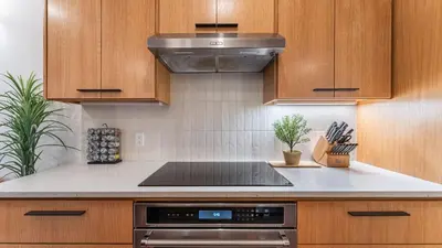 a kitchen with wooden cabinets and a stove top oven at Northwood Mountain Views Sauna Balcony Tahoe Group Retreat in Incline Village