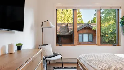 a bedroom with a window and a desk and a chair at Northwood Mountain Views Sauna Balcony Tahoe Group Retreat in Incline Village