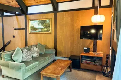 a living room with a couch and a tv at Tahoe Tranquility in Incline Village