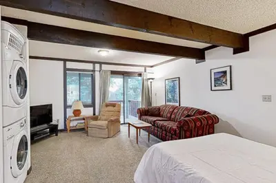 a room with a bed and a couch and a tv at Tahoe Tranquility in Incline Village