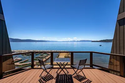 a balcony with chairs and a view of the water at Newley remodeled, two story, two-bedroom condo nothing but Views of Lake Tahoe! in Incline Village